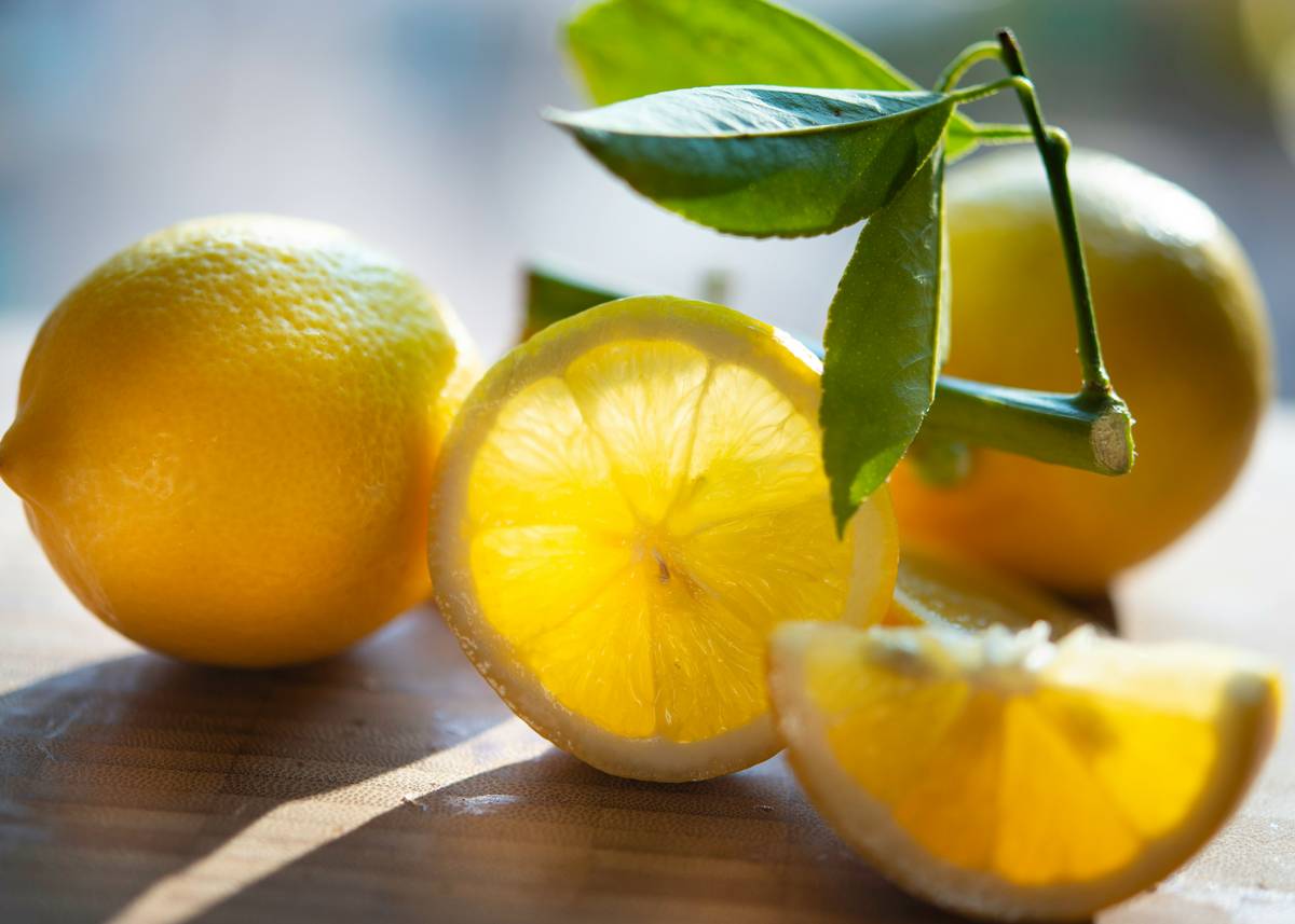 Lemon balm leaves next to supplement bottle labeled lemon sleep support aid