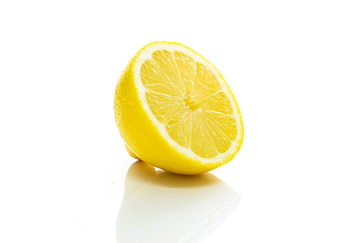 Woman peacefully sleeping with lemon sleep support aid bottle on nightstand